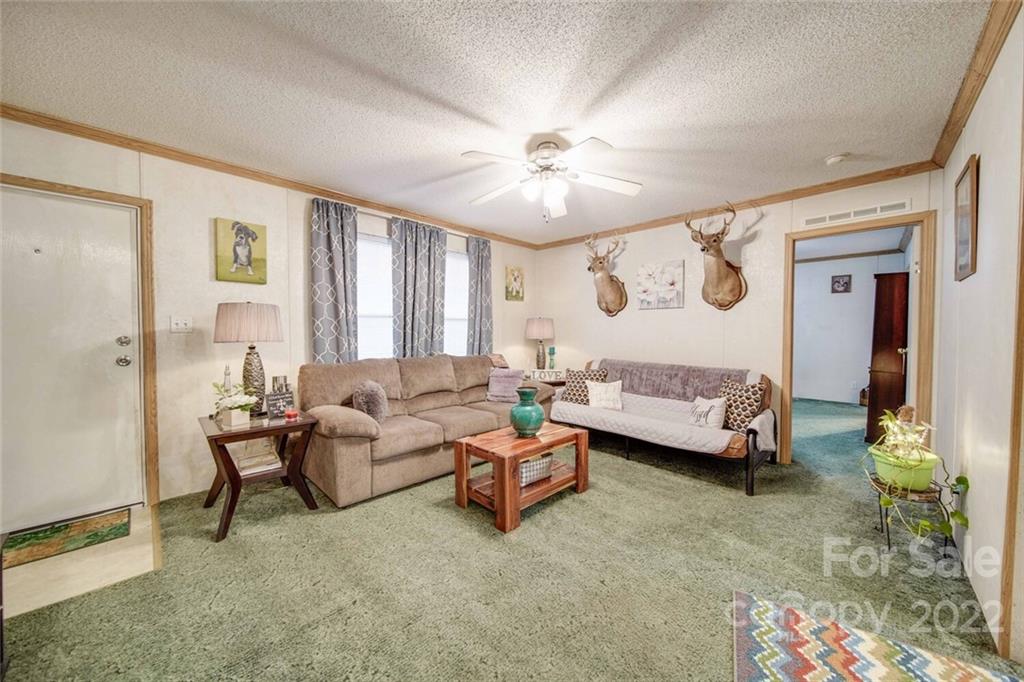 158 Smith Valley Road Sharon, SC 29742 - Photo 11 of 41 a living room with furniture and a chandelier