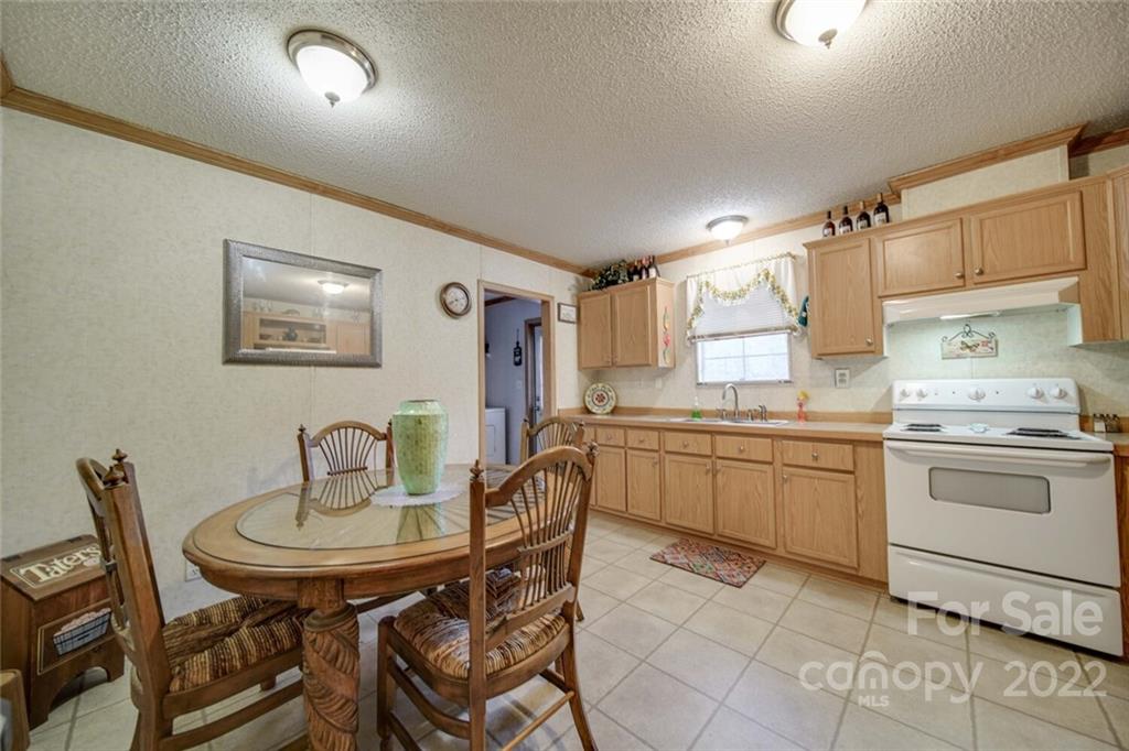 158 Smith Valley Road Sharon, SC 29742 - Photo 4 of 41 a kitchen with a dining table chairs and stove