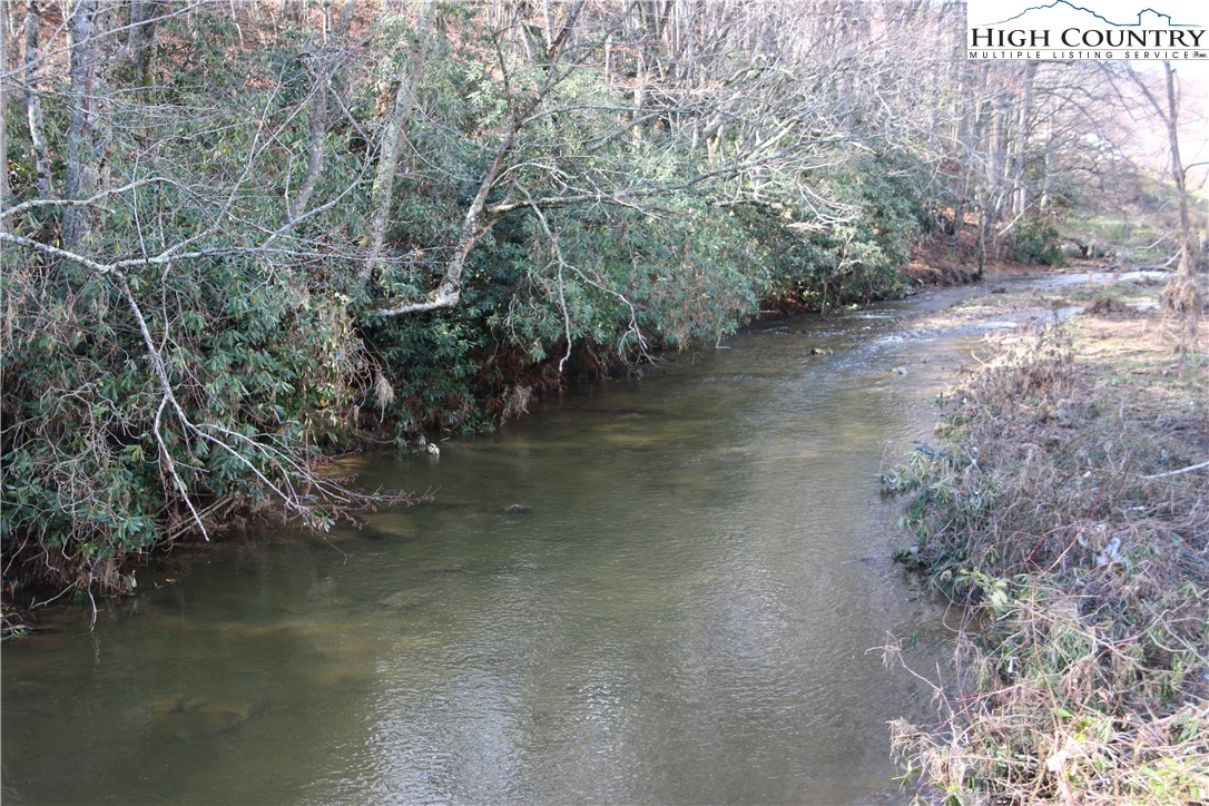 a view of a water pond with green space