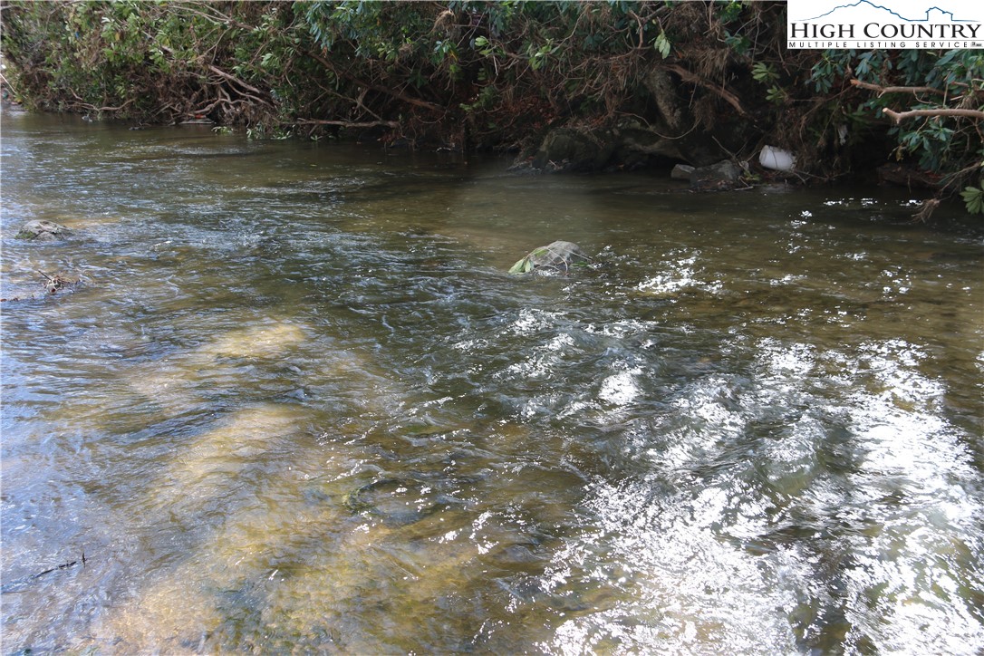 Big Laurel Road Creston, NC 28615 - Photo 3 of 27 a view of a large body of water with a tree in the background