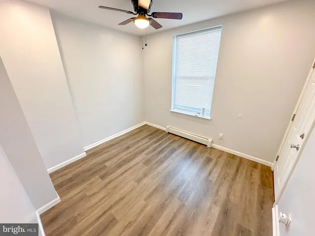 a view of room with window and ceiling fan