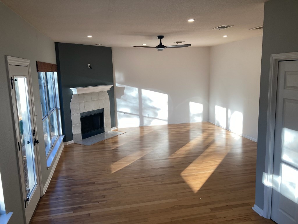 8116 Siringo Pass Austin, TX 78749 - Photo 2 of 9 a view of a hallway with wooden floor and a fireplace