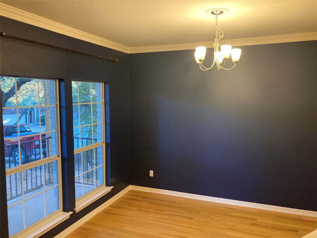 8116 Siringo Pass Austin, TX 78749 - Photo 4 of 9 a view of empty room with wooden floor and fan