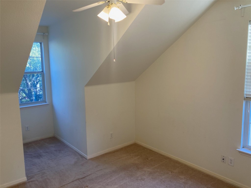 8116 Siringo Pass Austin, TX 78749 - Photo 9 of 9 an empty room with a chandelier fan