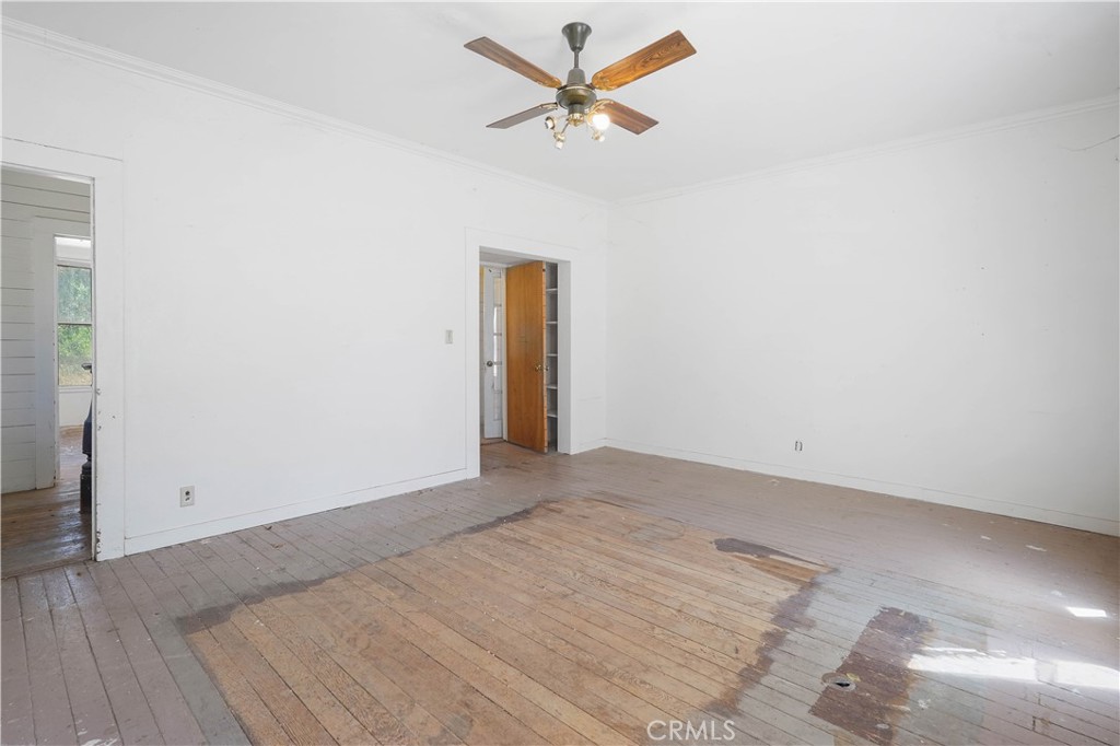 2010 Ladder Ridge Road Upper Lake, CA 95485 - Photo 20 of 75 an empty room with a ceiling fan and a window