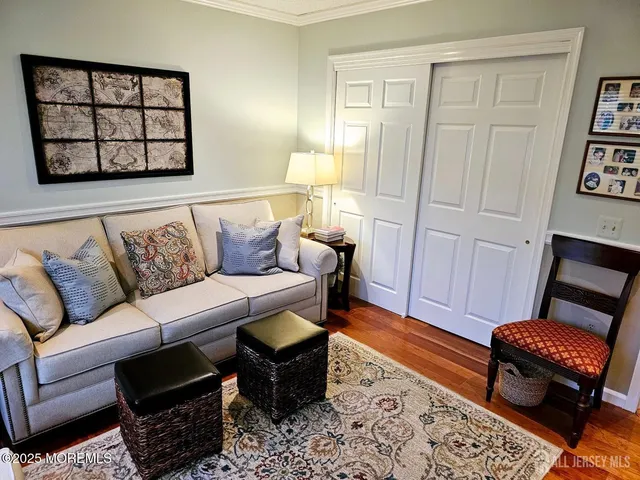 a living room with a rug and a flat screen tv