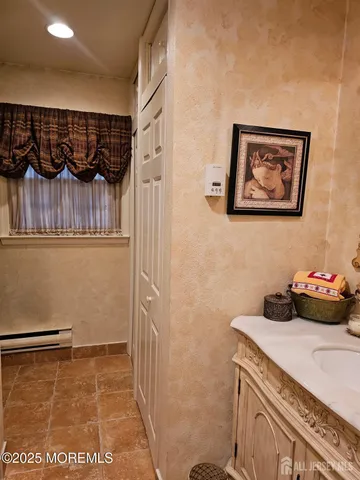 a white toilet sitting next to a bathroom and a shower