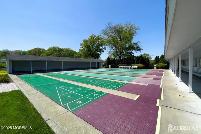 a view of a swimming pool with lawn chairs under an umbrella