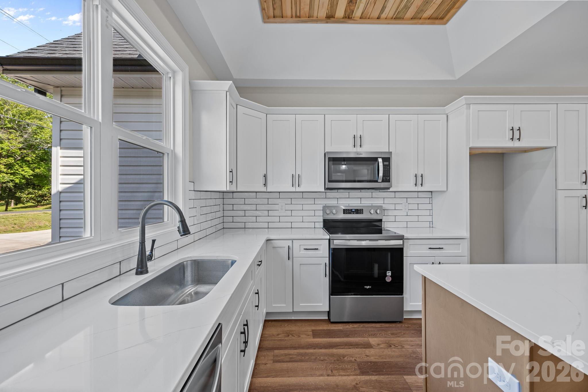 5037 Faith Road Salisbury, NC 28146 - Photo 20 of 45 a kitchen with sink a stove and microwave