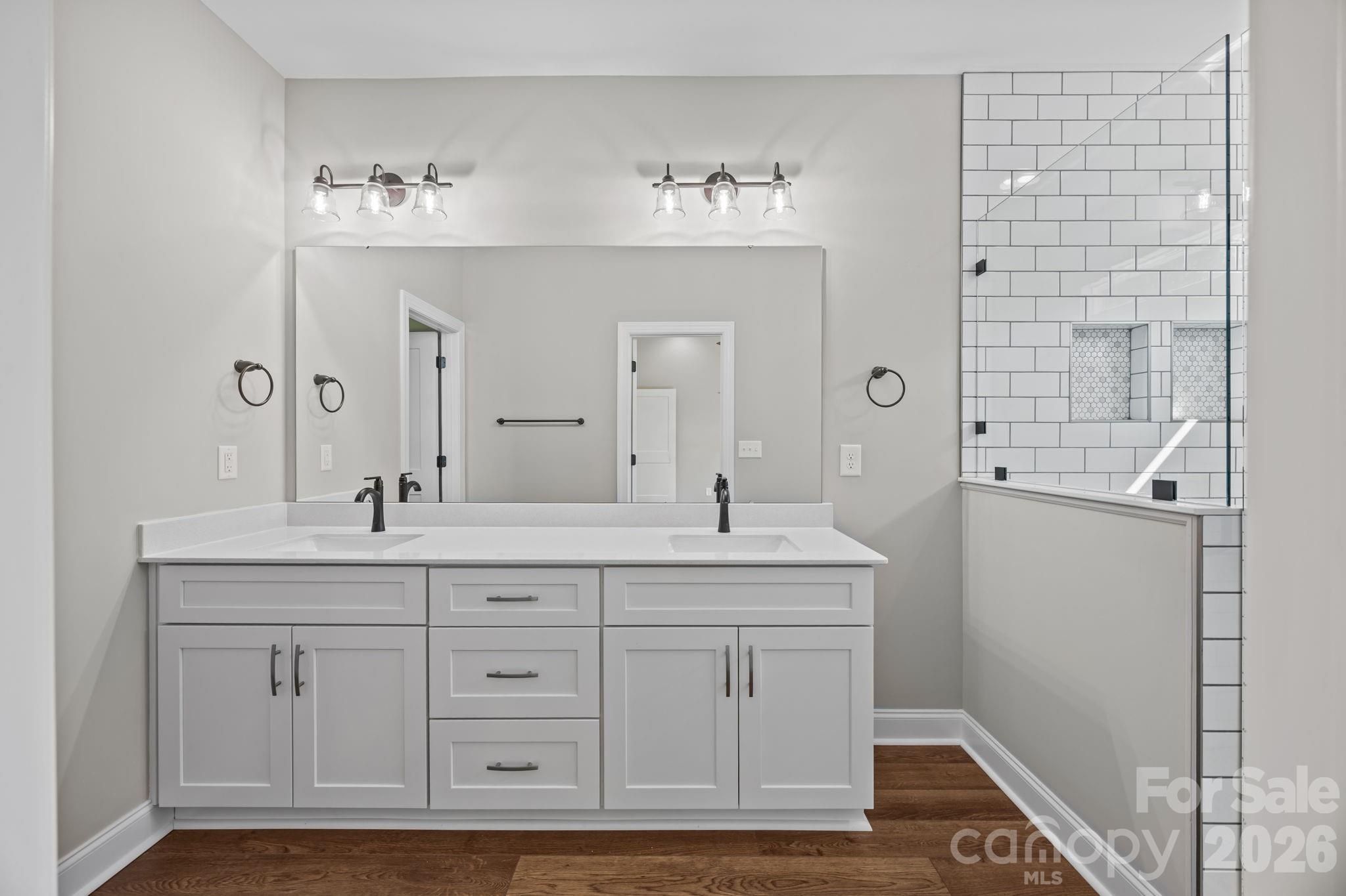 5037 Faith Road Salisbury, NC 28146 - Photo 23 of 45 a bathroom with a double vanity sink and a mirror