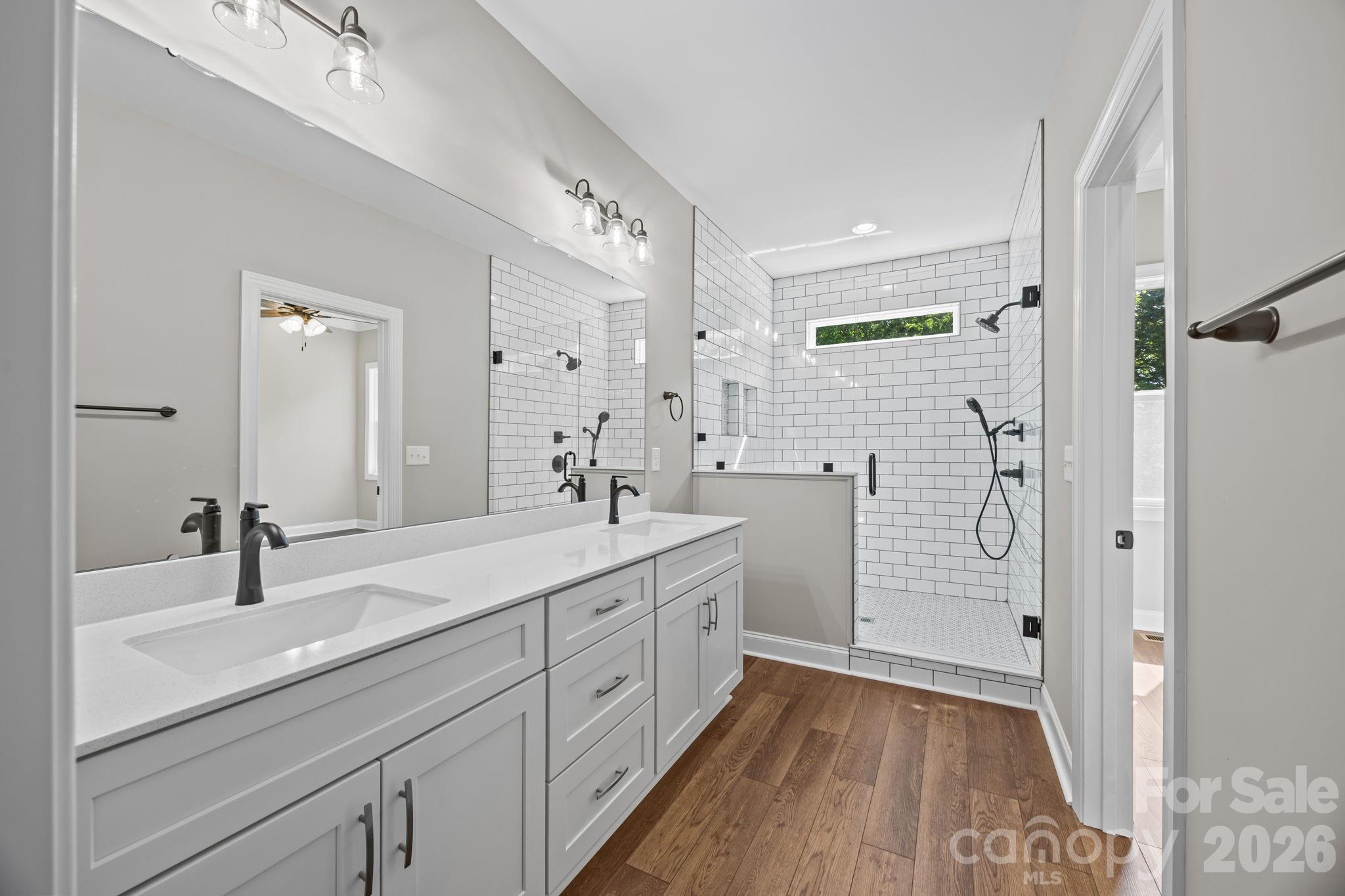 5037 Faith Road Salisbury, NC 28146 - Photo 24 of 45 a spacious bathroom with a shower sink and mirror