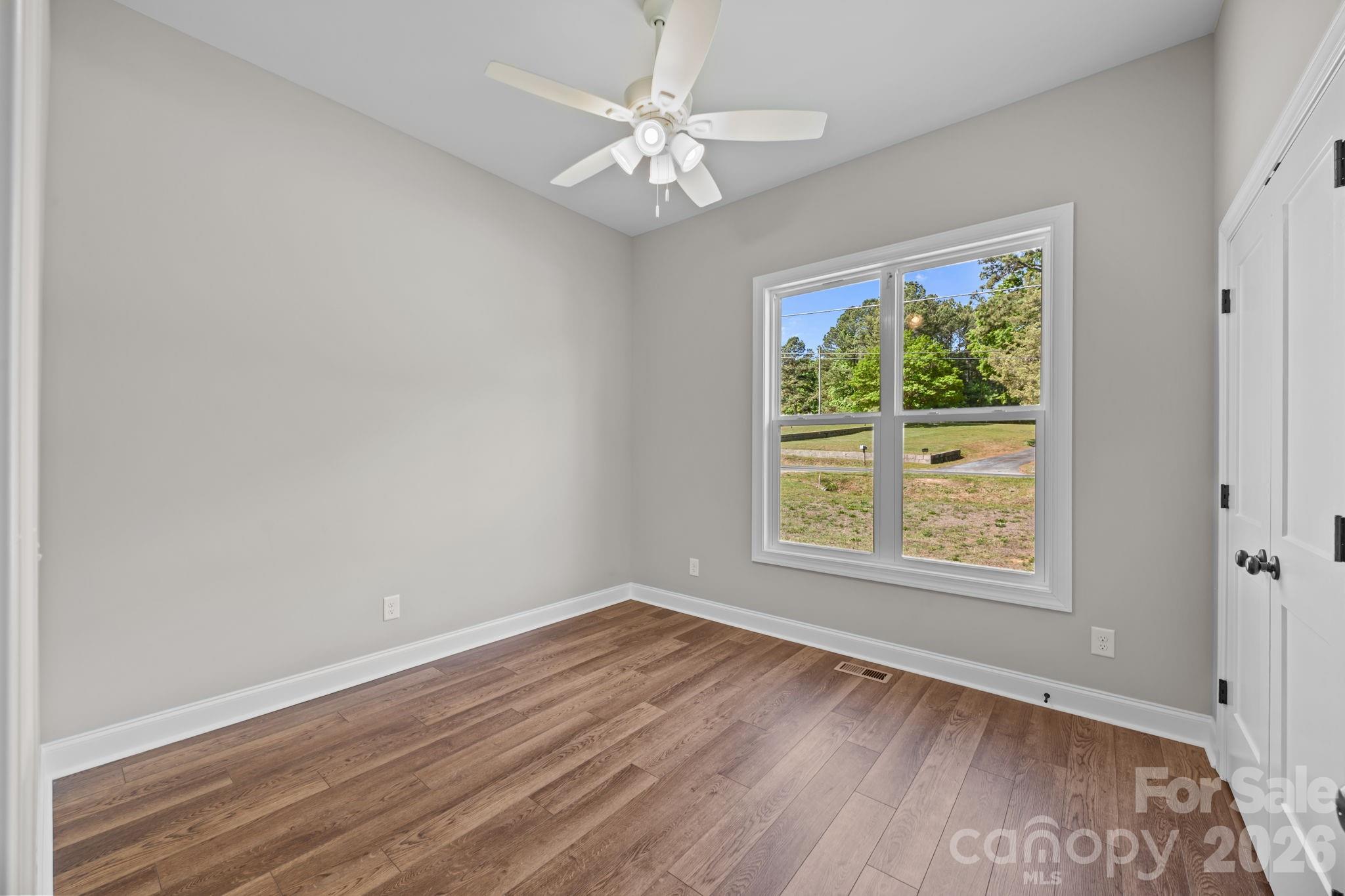 5037 Faith Road Salisbury, NC 28146 - Photo 27 of 45 a view of an empty room with wooden floor and a window