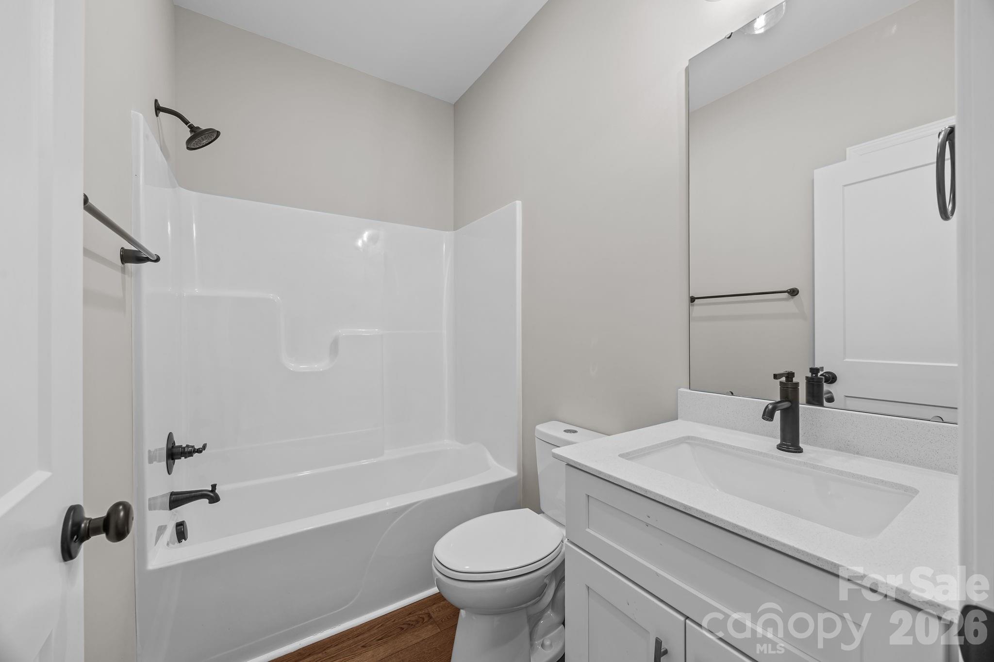 5037 Faith Road Salisbury, NC 28146 - Photo 29 of 45 a bathroom with a sink a toilet and a mirror