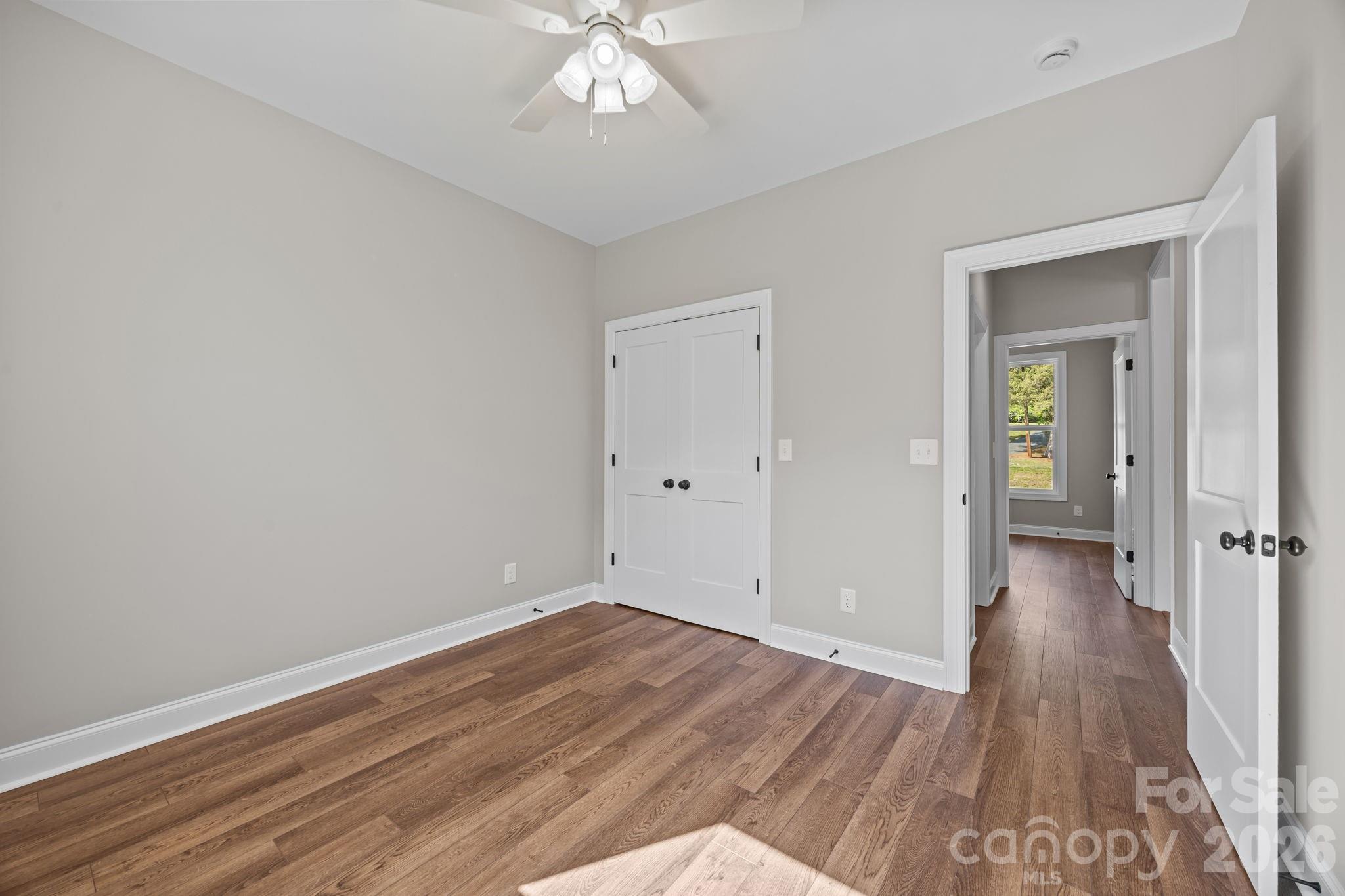 5037 Faith Road Salisbury, NC 28146 - Photo 31 of 45 a view of an empty room with wooden floor