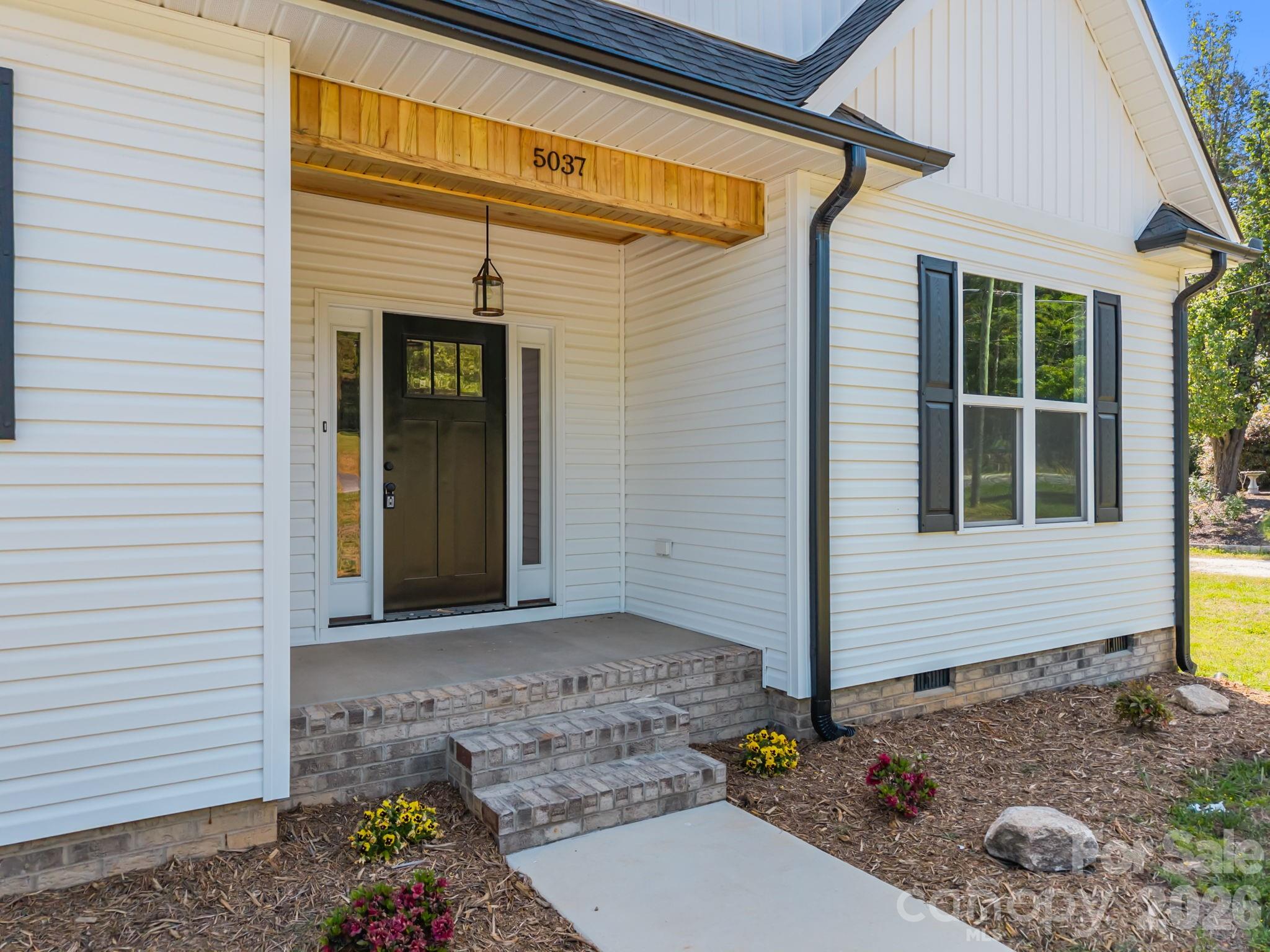 5037 Faith Road Salisbury, NC 28146 - Photo 5 of 45 a front view of a house with garden