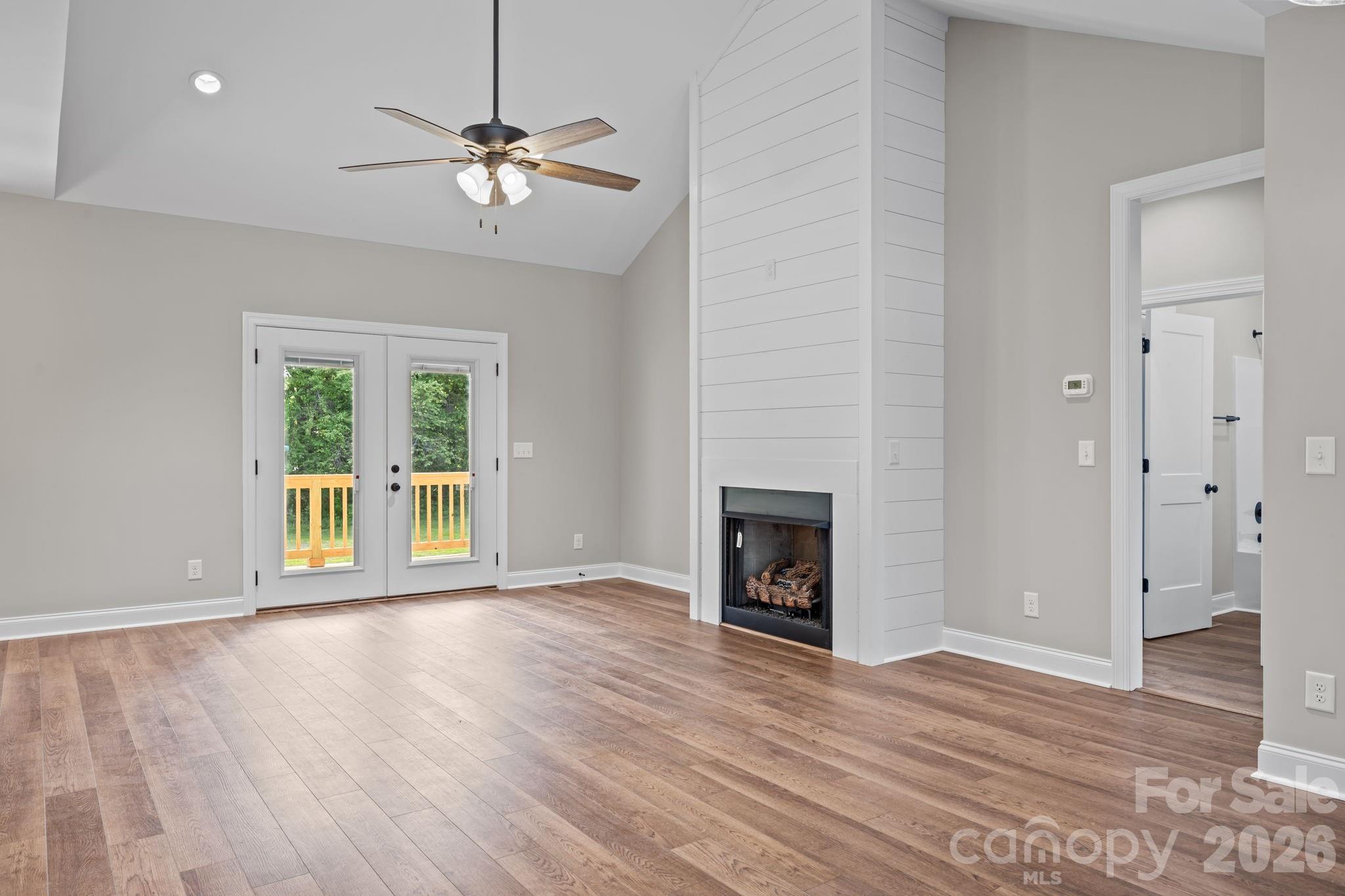 5037 Faith Road Salisbury, NC 28146 - Photo 9 of 45 a view of a livingroom with wooden floor and a ceiling fan