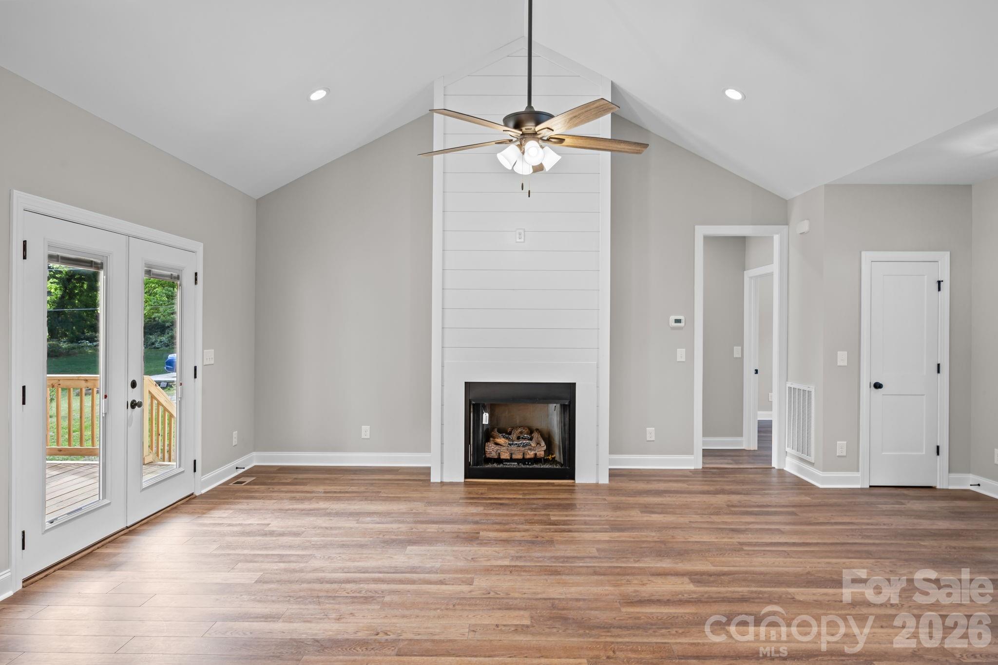5037 Faith Road Salisbury, NC 28146 - Photo 10 of 45 a view of an empty room with wooden floor and a window