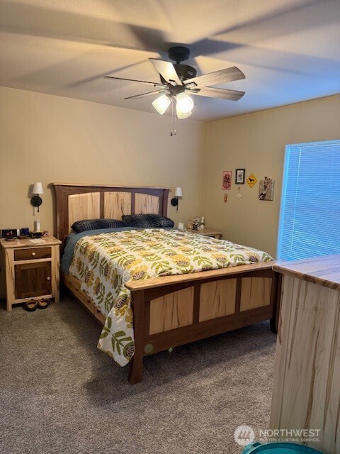 94 Grafton Road Wauconda, WA 98859 - Photo 23 of 37 a bedroom with a bed and a chandelier