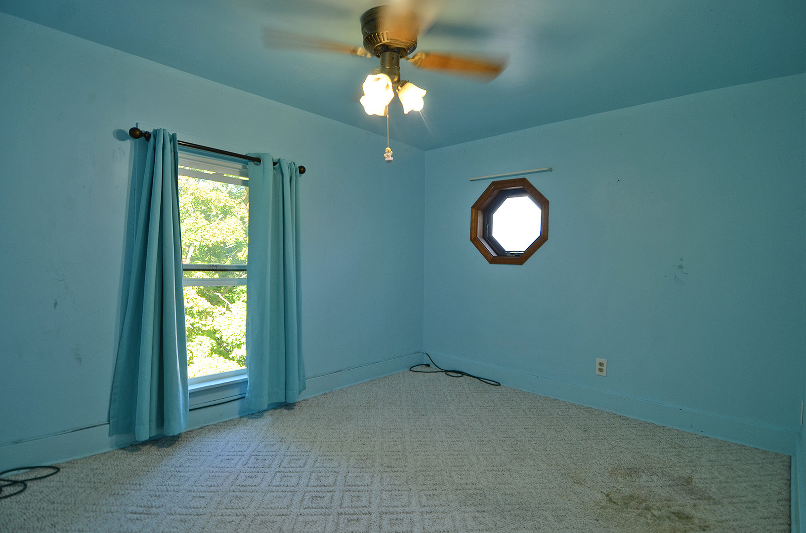 708 Lundy Street Streator, IL 61364 - Photo 12 of 21 an empty room with a chandelier fan and windows