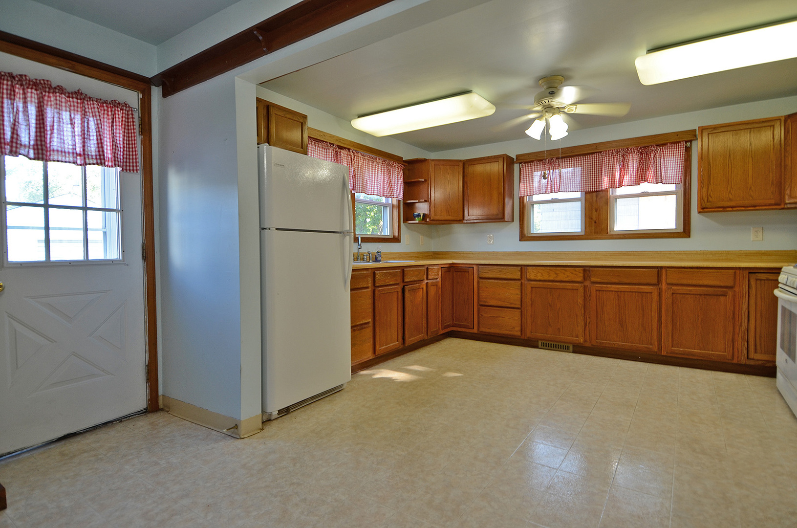 708 Lundy Street Streator, IL 61364 - Photo 6 of 21 a large kitchen with a sink and dishwasher a refrigerator with wooden floor