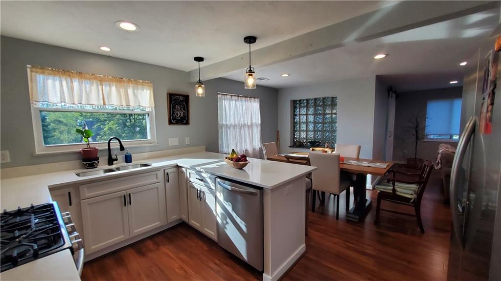 12106 Center Street Irwin, PA 15642 - Photo 11 of 27 a kitchen with sink cabinets and wooden floor