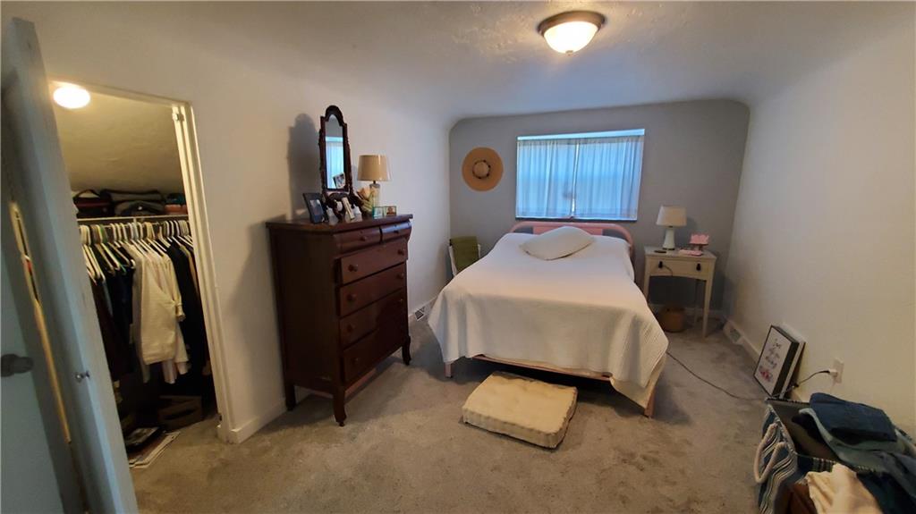 12106 Center Street Irwin, PA 15642 - Photo 15 of 27 a bedroom with a bed and a mirror