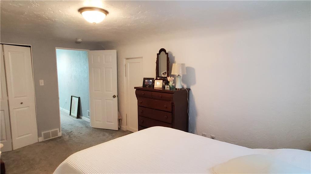 12106 Center Street Irwin, PA 15642 - Photo 16 of 27 a bedroom with a bed and a dresser