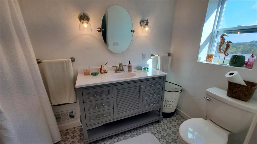 12106 Center Street Irwin, PA 15642 - Photo 18 of 27 a bathroom with a toilet sink and mirror