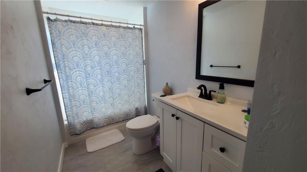 12106 Center Street Irwin, PA 15642 - Photo 21 of 27 a bathroom with a sink a toilet and shower