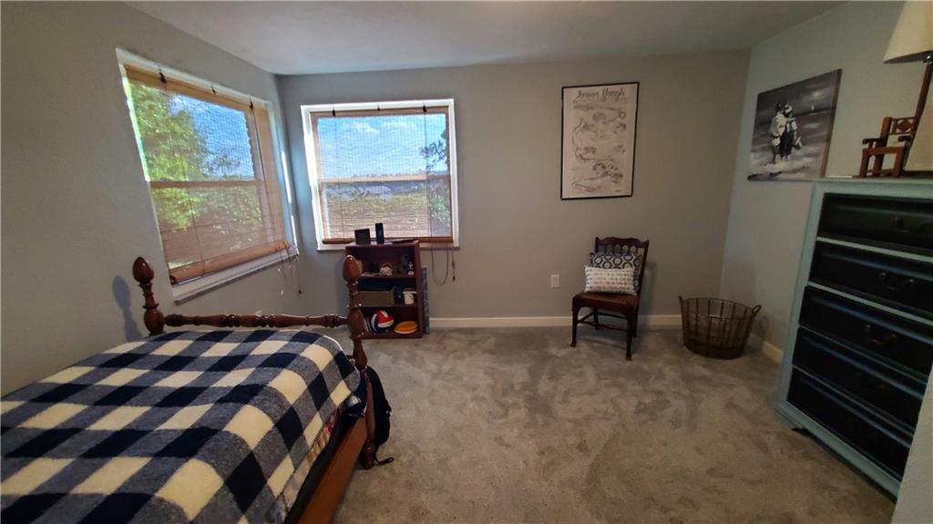 12106 Center Street Irwin, PA 15642 - Photo 23 of 27 a bedroom with a bed a standing fan and a window