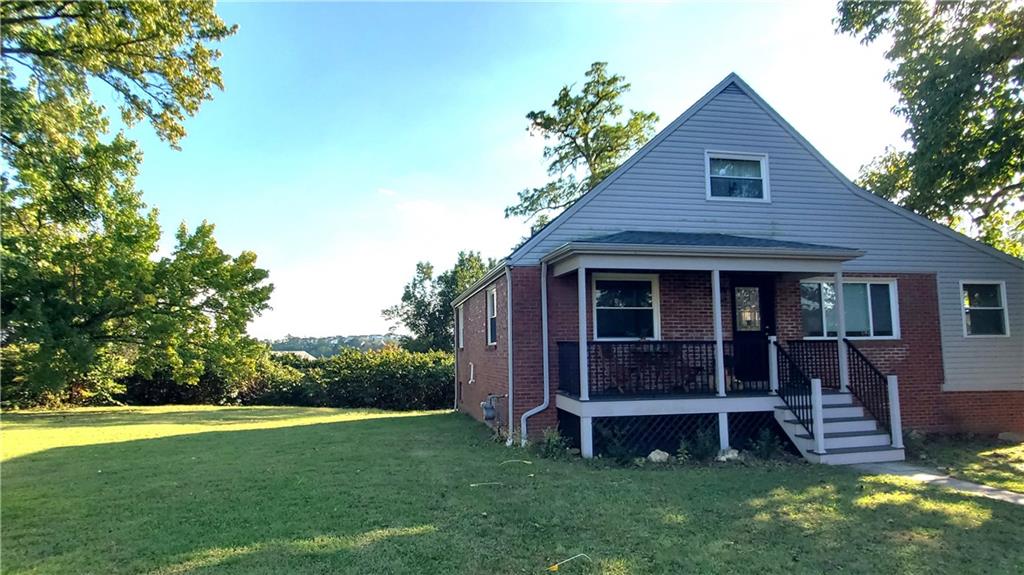 12106 Center Street Irwin, PA 15642 - Photo 27 of 27 a view of a house with a yard potted plants and large tree