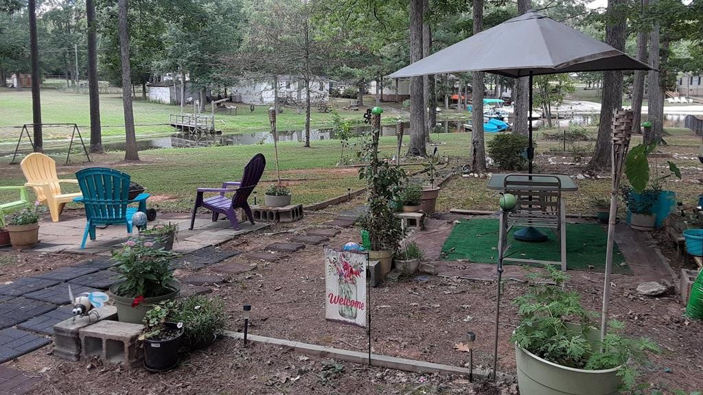 136 Redbud Lane Saluda, SC 29138 - Photo 14 of 17 a view of a patio with chairs potted plants and a yard