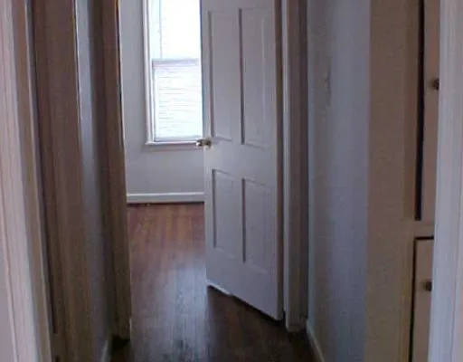 a view of front door with wooden floor