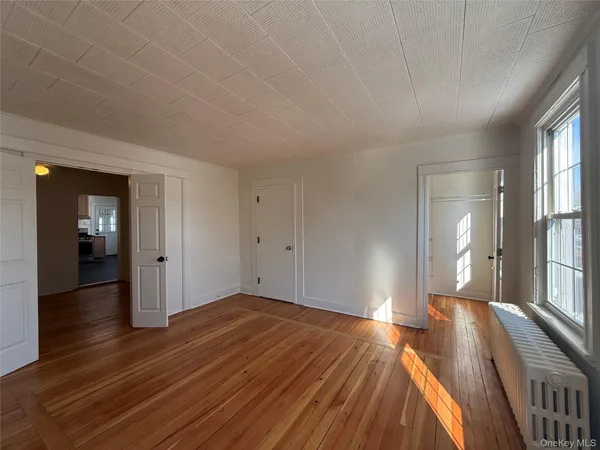 a bedroom with a bed and closet with wooden floor