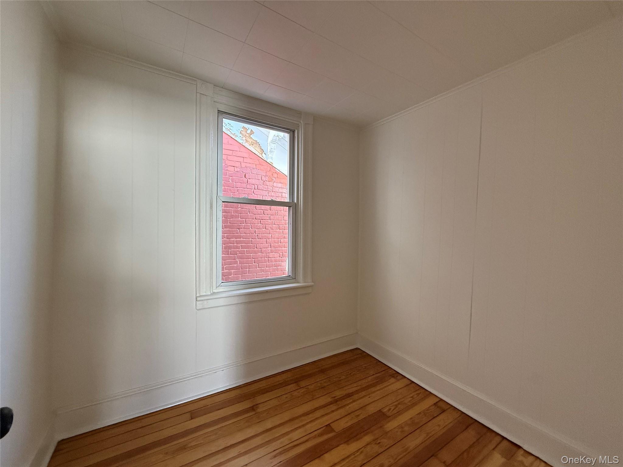 40 North Clover Street Poughkeepsie, NY 12601 - Photo 10 of 11 a view of an empty room with wooden floor and a window