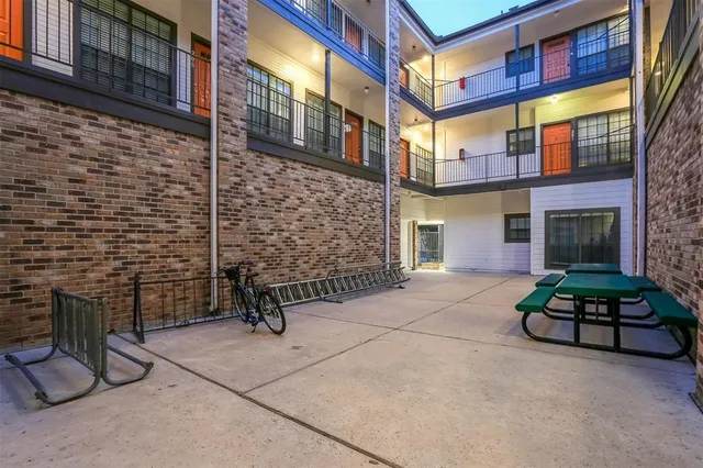 a brick building with a bench in front of it