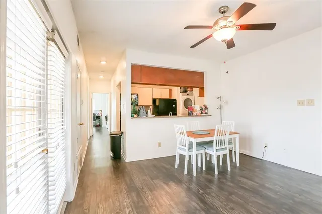 a dining room with furniture window and wooden floor