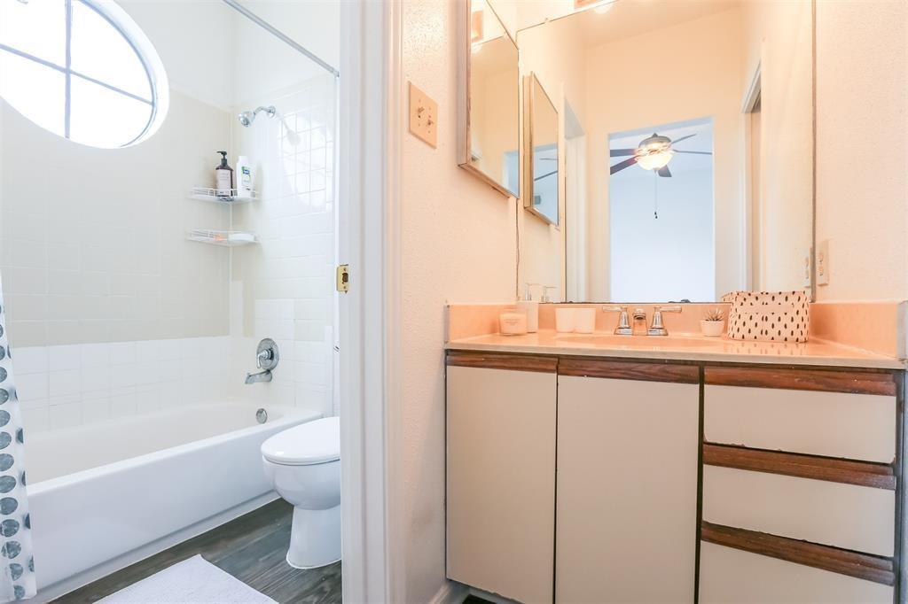 912 West 22nd Street, Unit 302 Austin, TX 78705 - Photo 7 of 17 a bathroom with a granite countertop sink a toilet and bathtub
