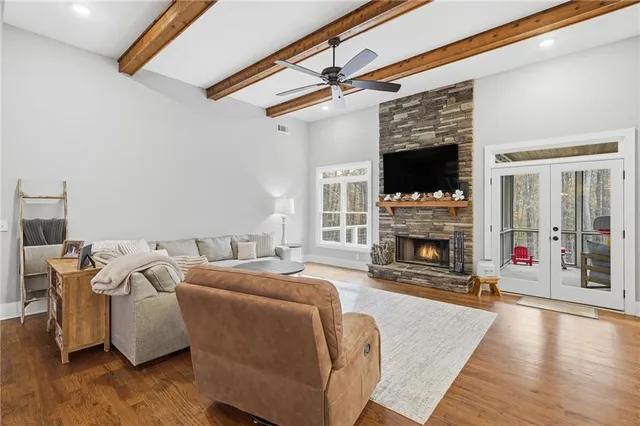 a living room with furniture a fireplace and a flat screen tv