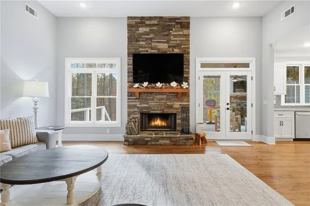 a living room with furniture a flat screen tv and a fireplace