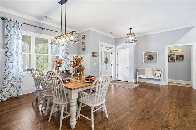 a view of a dining room with furniture window and wooden floor