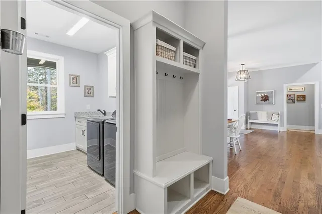 a view of a hallway with wooden floor and a living room