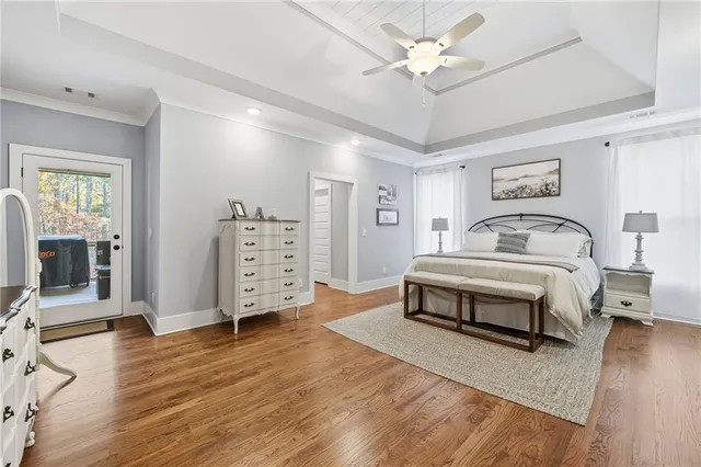 a bedroom with furniture and wooden floor