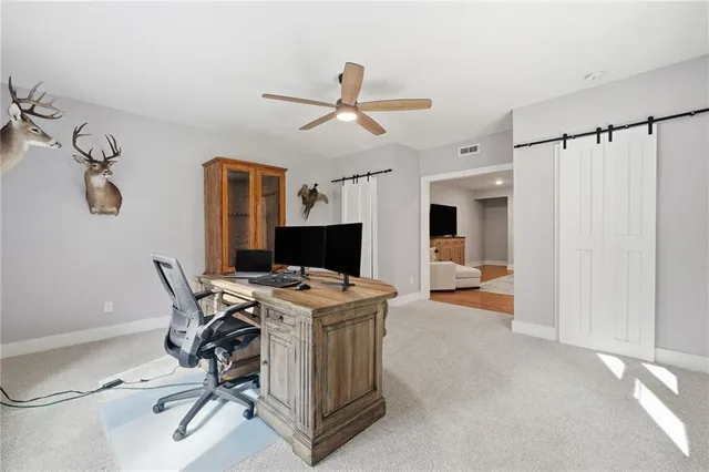 a view of a livingroom with workspace and a window