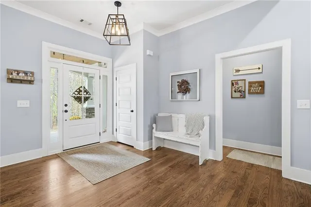 a view of livingroom with hardwood floor and white walls