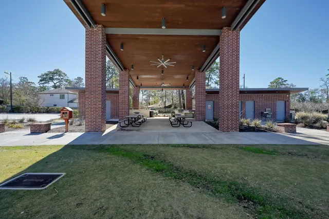 a view of a patio with table and chairs with plants and wooden fence