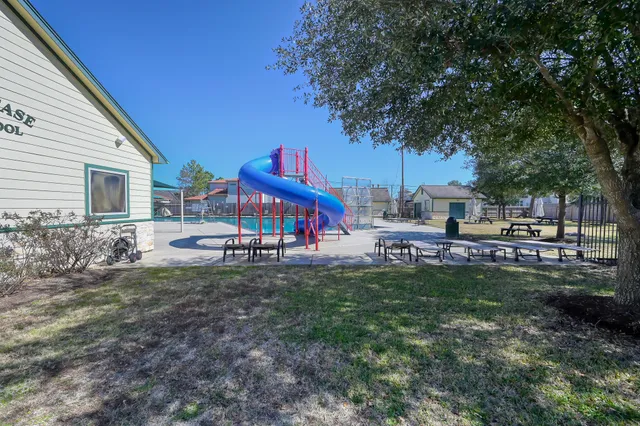 a view of a house with backyard and sitting area