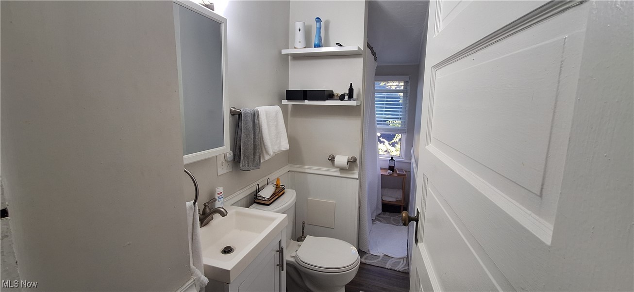 1477 Genesee Road South Euclid, OH 44121 - Photo 16 of 26 Half bathroom with vanity and dark wood-type flooring