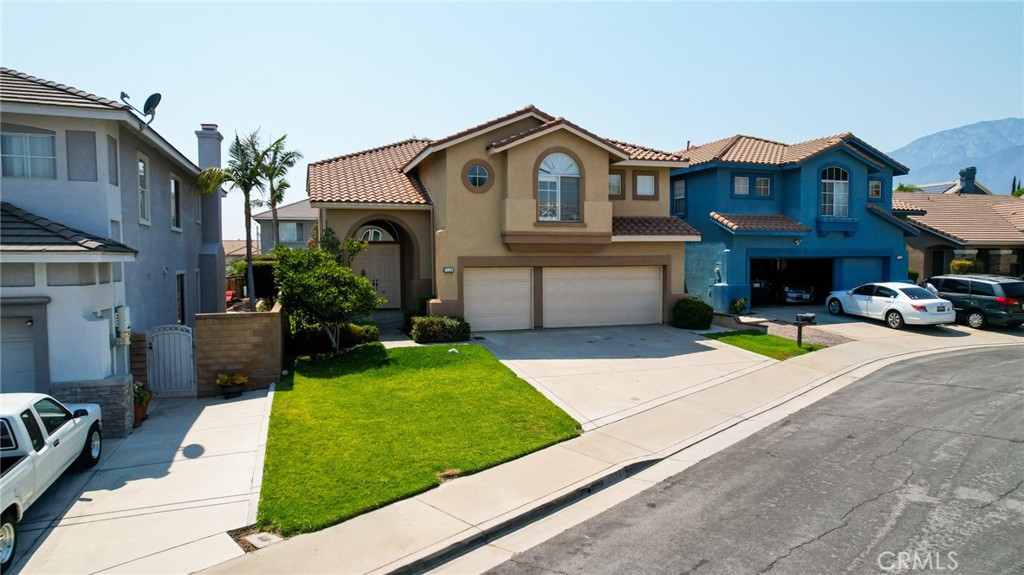 7116 Sapri Place Rancho Cucamonga, CA 91701 - Photo 1 of 52 a view of multiple houses with a yard and potted plants