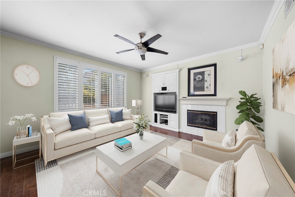 7116 Sapri Place Rancho Cucamonga, CA 91701 - Photo 14 of 52 a living room with furniture a fireplace and a large window